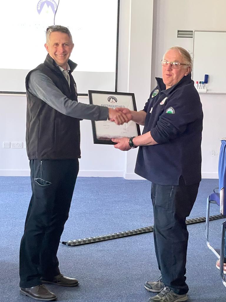 Brian receiving his Distinguished Service Award from Damon Powell